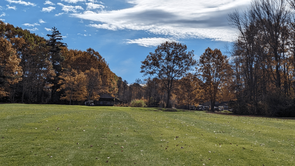Golf course fairway with autumnal trees